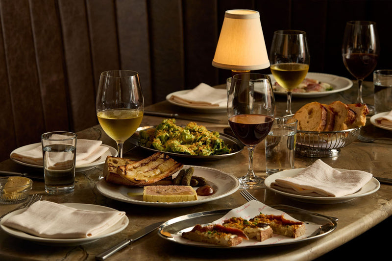 NEOZ Victoria cordless table lamp illuminating a dining table at Bistro Saine, Auckland.
