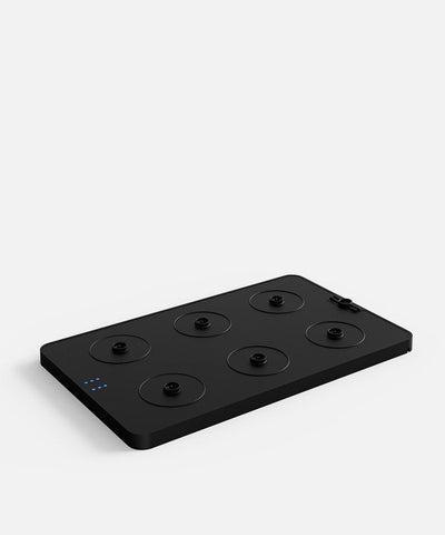 NEOZ N1 Charging Tray – sleek black charging base with six contact points for cordless table lamps.